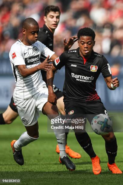 Leon Bailey of Bayer Leverkusen and Gelson Fernandes of Eintracht Frankfurt battle for the ball during the Bundesliga match between Bayer 04...