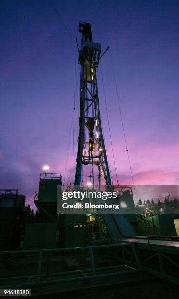 Meter triple rig is seen at dusk, August 21 in Drayton Valley, Alberta, Canada. The gas drilling rig is owned and operated by Precision Drilling who...