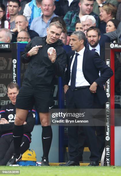 Chris Hughton, Manager of Brighton and Hove Albion speaks to the fourth official Graham Scott during the Premier League match between Crystal Palace...