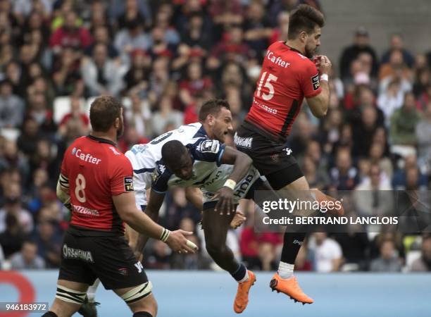 Toulon's French fullback Hugo Bonneval vies for a high ball with Montpellier's French winger Gabriel Ngandebe and Montpellier's New Zealand fly half...