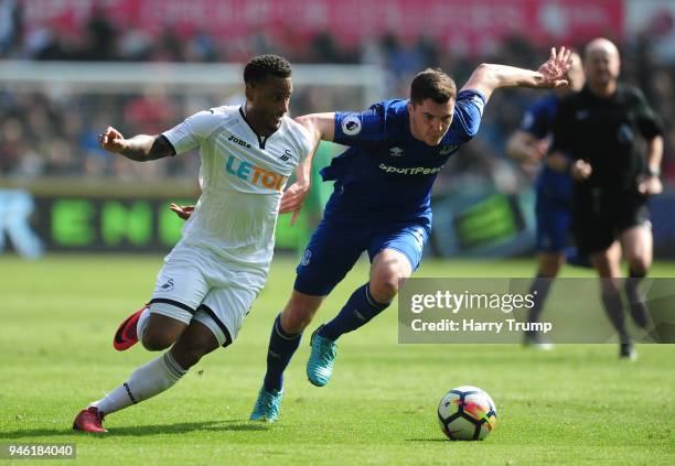 Luciano Narsingh of Swansea City is challenged by Michael Keane of Everton during the Premier League match between Swansea City and Everton at...