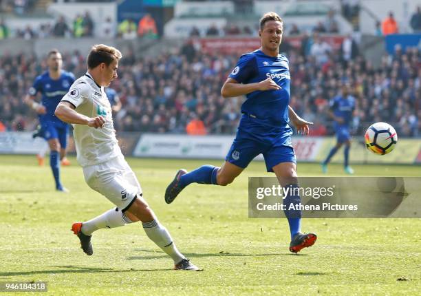 Tom Carroll of Swansea City takes a shot past Phil Jagielka of Everton during the Premier League match between Swansea City and Everton at The...