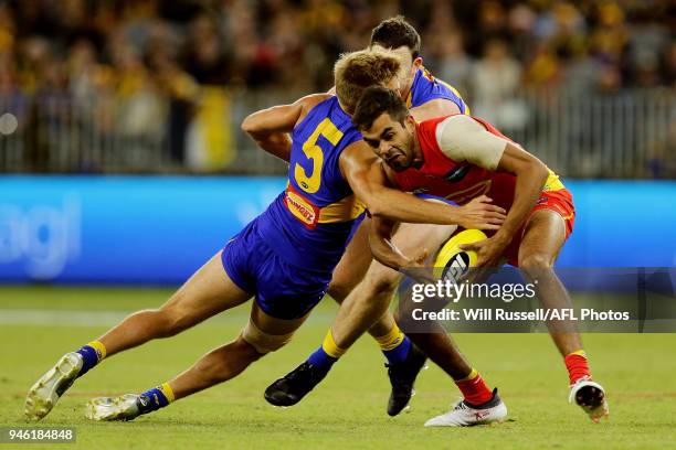 Jack Martin of the Suns is tackled by Brad Sheppard of the Eagles during the round four AFL match between the West Coast Eagles and the Gold Coast...