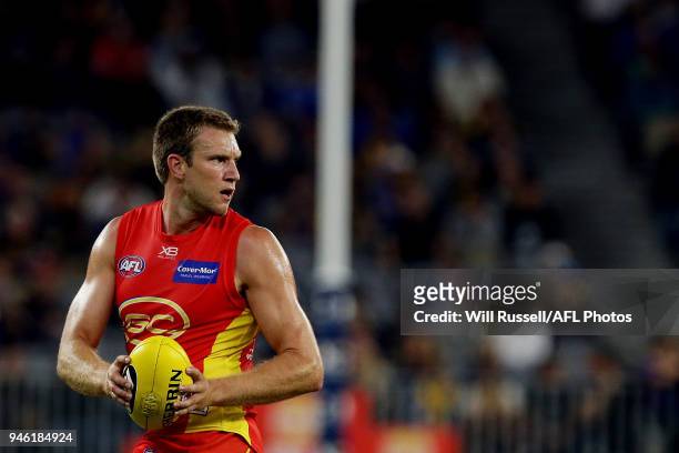 Sam Day of the Suns looks to pass the ball during the round four AFL match between the West Coast Eagles and the Gold Coast Suns at Optus Stadium on...
