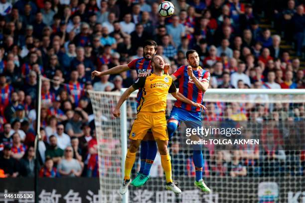 Crystal Palace's English defender James Tomkins and Crystal Palace's Serbian midfielder Luka Milivojevic go up against Brighton's English striker...