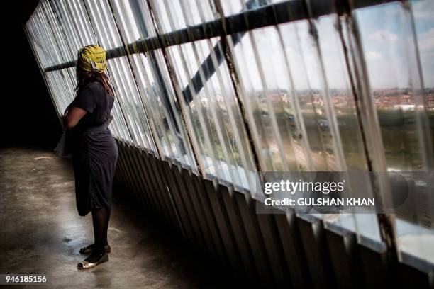 Mourner listens standing in the grounds of the Orlando Stadium in the township of Soweto during the funeral of the late anti-apartheid champion...