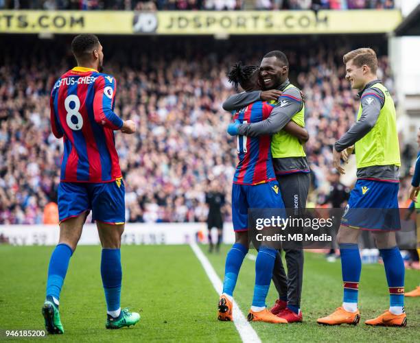 Wilfried Zaha of Crystal Palace celebrates wioth team-mate Christian Benteke after scoring their third goal during the Premier League match between...