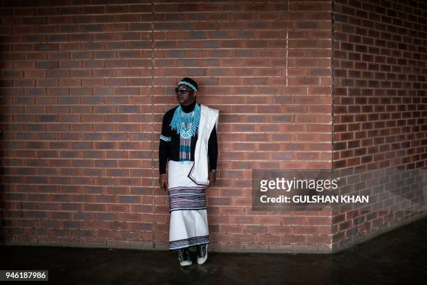 Mourner in traditional garb, stands in the grounds of the Orlando Stadium in the township of Soweto, during the funeral of the late anti-apartheid...