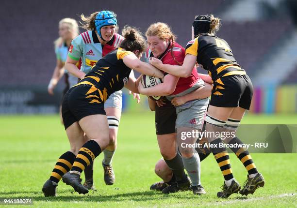 Chloe Edwards of Harlequins Ladies is tackled by Amy Cokayne and Alice Sheffield of Wasps FC Ladies during the Premier 15s Semi Final 2nd Leg between...