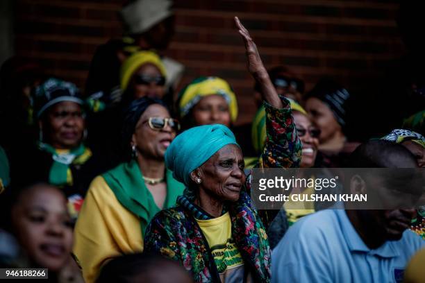 Mourner reacts from the stands of the full 37,500-seater Orlando Stadium in the township of Soweto during the funeral of the late anti-apartheid...