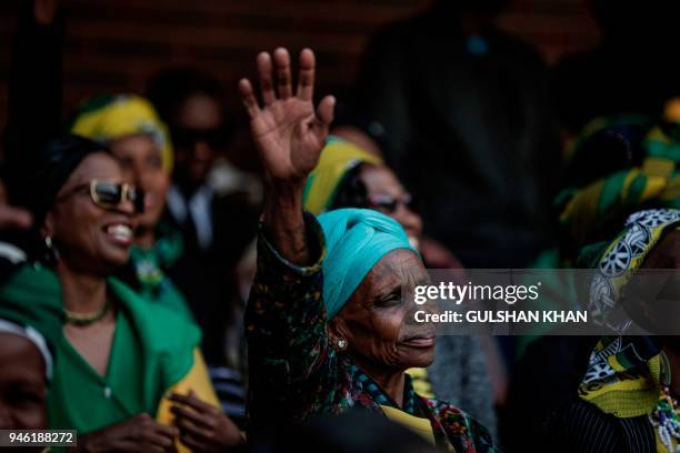 Mourner reacts from the stands of the full 37,500-seater Orlando Stadium in the township of Soweto during the funeral of the late anti-apartheid...