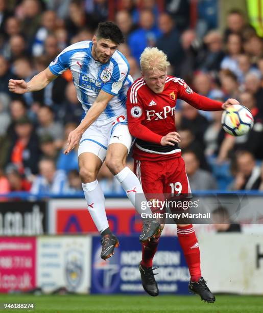 Christopher Schindler of Huddersfield Town competes for a header with Will Hughes of Watford during the Premier League match between Huddersfield...
