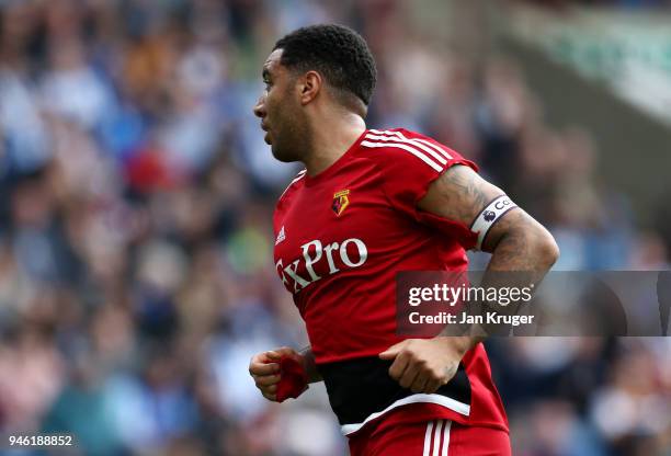 Troy Deeney of Watford runs with a wripped shirt during the Premier League match between Huddersfield Town and Watford at John Smith's Stadium on...