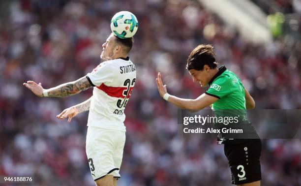 Daniel Ginczek of Stuttgart jumps for a header with Miiko Albornoz of Hannover during the Bundesliga match between VfB Stuttgart and Hannover 96 at...