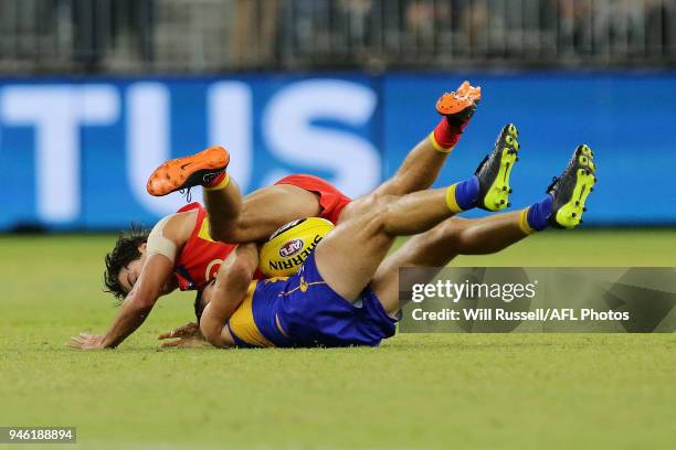 Jamie Cripps of the Eagles is tackled by Jack Bowes of the Suns during the round four AFL match between the West Coast Eagles and the Gold Coast Suns...