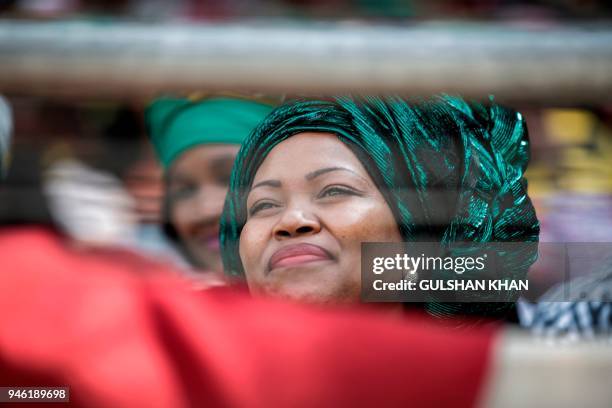 Mourner reacts as she sits in the stands of the full 37,500-seater Orlando Stadium in the township of Soweto during the funeral of the late...