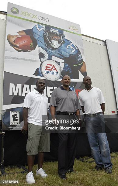 From left to right, football players Marshall Faulk, running back for the St. Louis Rams, Warren Moon, former quarterback for the Kansas City Chiefs,...