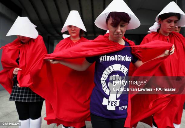 Activists dressed as 'Handmaids' at a rally for Equality, Freedom &amp; Choice organised by ROSA - Socialist Feminist Movement at Liberty Hall in...