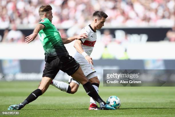 Erik Thommy of Stuttgart is challenged by Niclas Fuellkrug of Hannover during the Bundesliga match between VfB Stuttgart and Hannover 96 at...