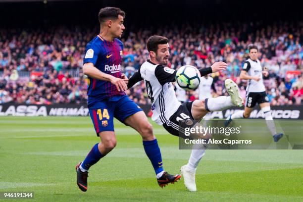 Jose Gaya of FC Barcelona clears the ball under pressure from Philippe Coutinho of FC Barcelona during the La Liga match between Barcelona and...