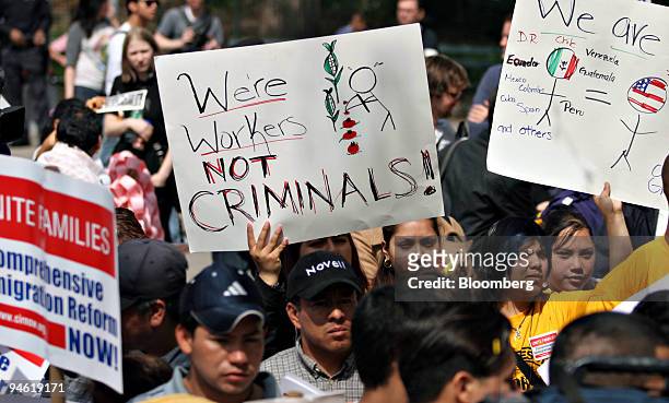 Demonstrators hold signs during a rally in support of immigrant rights in Washington Square Park, Tuesday, May 1, 2007 in New York.