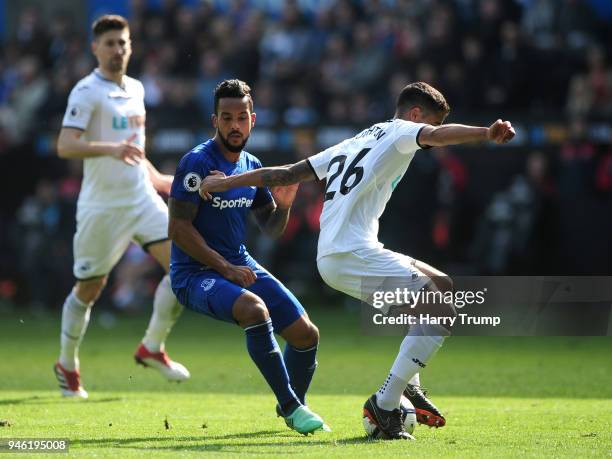 Kyle Naughton of Swansea City wins the ball from Theo Walcott of Everton during the Premier League match between Swansea City and Everton at Liberty...