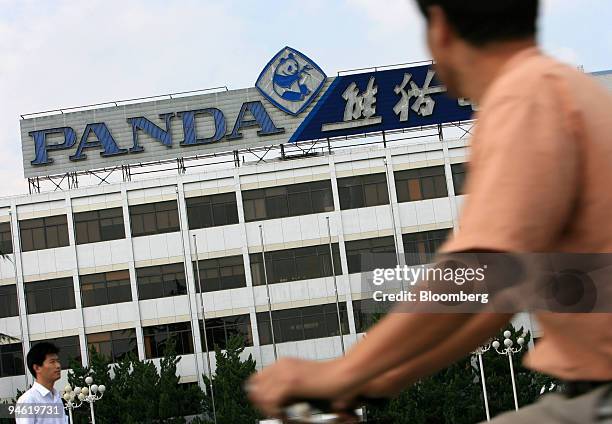 Man rides his bicycle past Nanjing Panda Electronics Co. Ltd. Headquarters in Nanjing, Jiangsu province, China, Sunday, August 20, 2006. Nanjing...