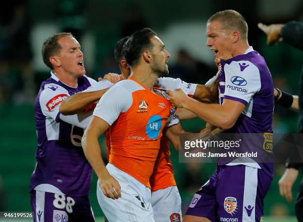 Shane Lowry of the Perth Glory and Jack Hingert of the Brisbane Roar grab jumpers during a players scuffle during the round 27 A-League match between...