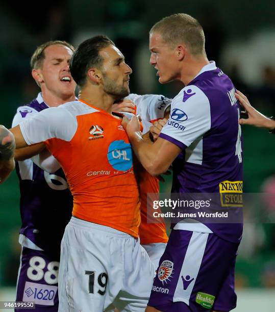 Shane Lowry of the Perth Glory and Jack Hingert of the Brisbane Roar grab jumpers during a players scuffle during the round 27 A-League match between...