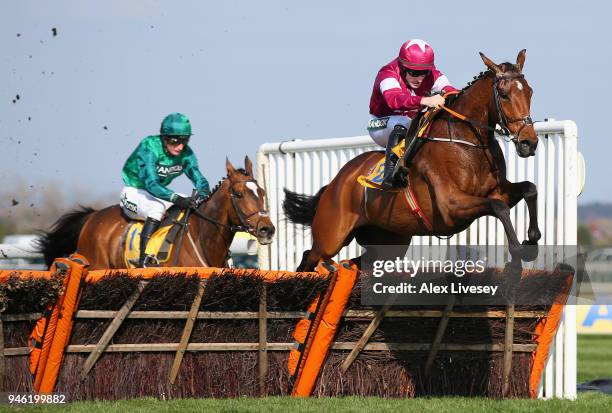 Identity Thief ridden by Sean Flanagan clears the last fence on their way to winning the Ryanair Stayers Hurdle at Aintree Racecourse on April 14,...