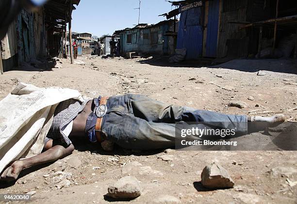 Man's body lies on the street in the Mathare district of Nairobi, Kenya, on Thursday, Jan. 3, 2008. Kenya's main opposition party postponed a rally...