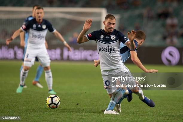James Troisi of Melbourne is tackled by Sydney's Brandon O'Neill during the round 27 A-League match between the Sydney FC and he Melbourne Victory at...
