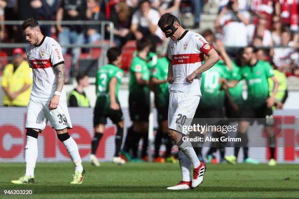 Christian Gentner and Daniel Ginczek of Stuttgart react after Niclas Fuellkrug of Hannover scored his team's first goal during the Bundesliga match...