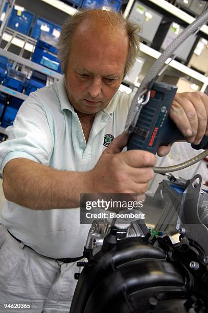 Workers assemble engines at the Skoda plant in Mlada Boleslav, Czech Republic, Thursday, October 19, 2006.