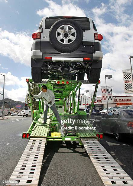 Truck-transport driver George Hernandez unloads Toyota FJ Cruisers at the Toyota of El Cajon dealership in El Cajon, California, on Wednesday, Feb....