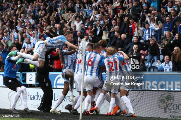 Tom Ince of Huddersfield Town celebrates with teammates after scoring his sides first goal during the Premier League match between Huddersfield Town...