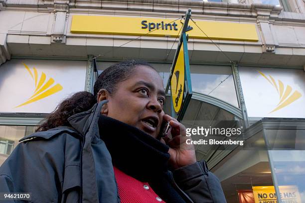 Sprint customer Gina Monteiro talks on her phone outside a Sprint store in Boston, Massachusetts, on Wednesday, Feb. 28, 2007. SK Telecom Co., South...