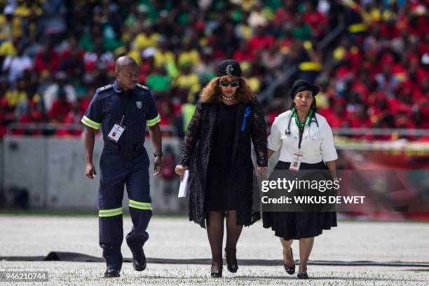 Zenani Mandela-Dlamini, a daughter of the late anti-apartheid icon Winnie Madikizela-Mandela, is escorted by medical staff after making her speech...