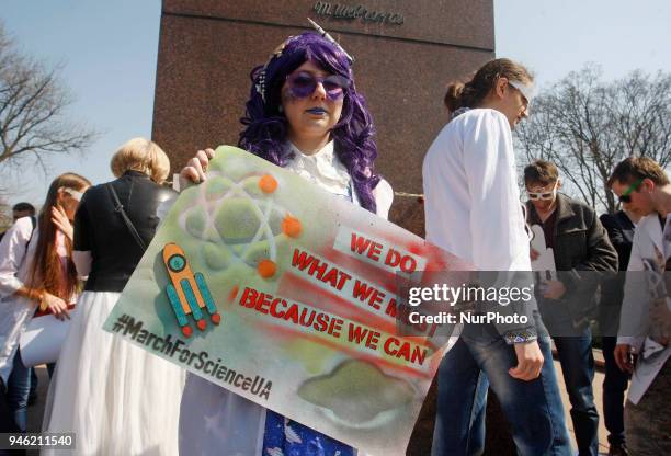 People carry placards reading like &quot;Who you gonna call?&quot;, &quot;We do,what we must,because we can&quot;,&quot;Science is...