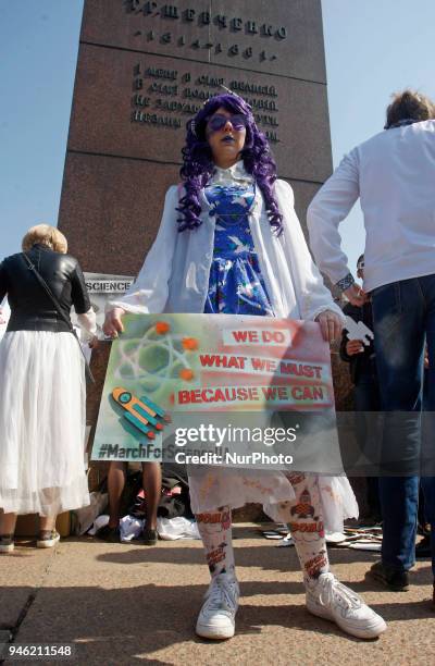 People carry placards reading like &quot;Who you gonna call?&quot;, &quot;We do,what we must,because we can&quot;,&quot;Science is...