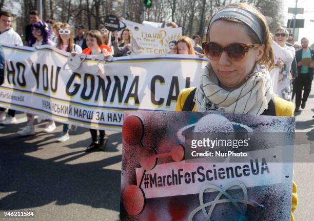 People carry placards reading like &quot;Who you gonna call?&quot;, &quot;We do,what we must,because we can&quot;,&quot;Science is...