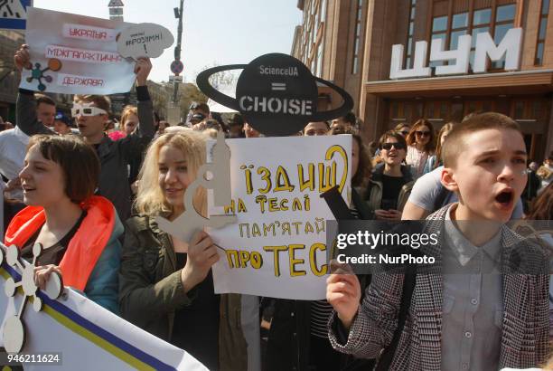 People carry placards reading like &quot;Who you gonna call?&quot;, &quot;We do,what we must,because we can&quot;,&quot;Science is...