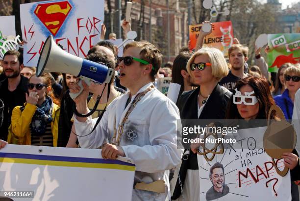 People carry placards reading like &quot;Who you gonna call?&quot;, &quot;We do,what we must,because we can&quot;,&quot;Science is...