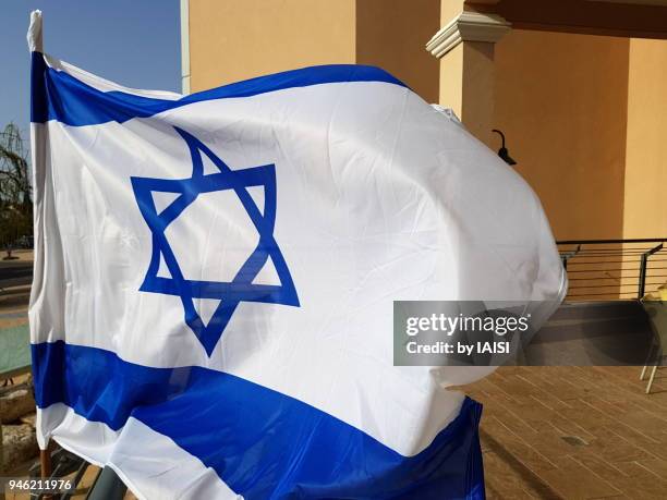 close-up of israeli flag on terrace by a bright and windy afternoon, israel's 70 years of independance - arab israeli conflict stock pictures, royalty-free photos & images