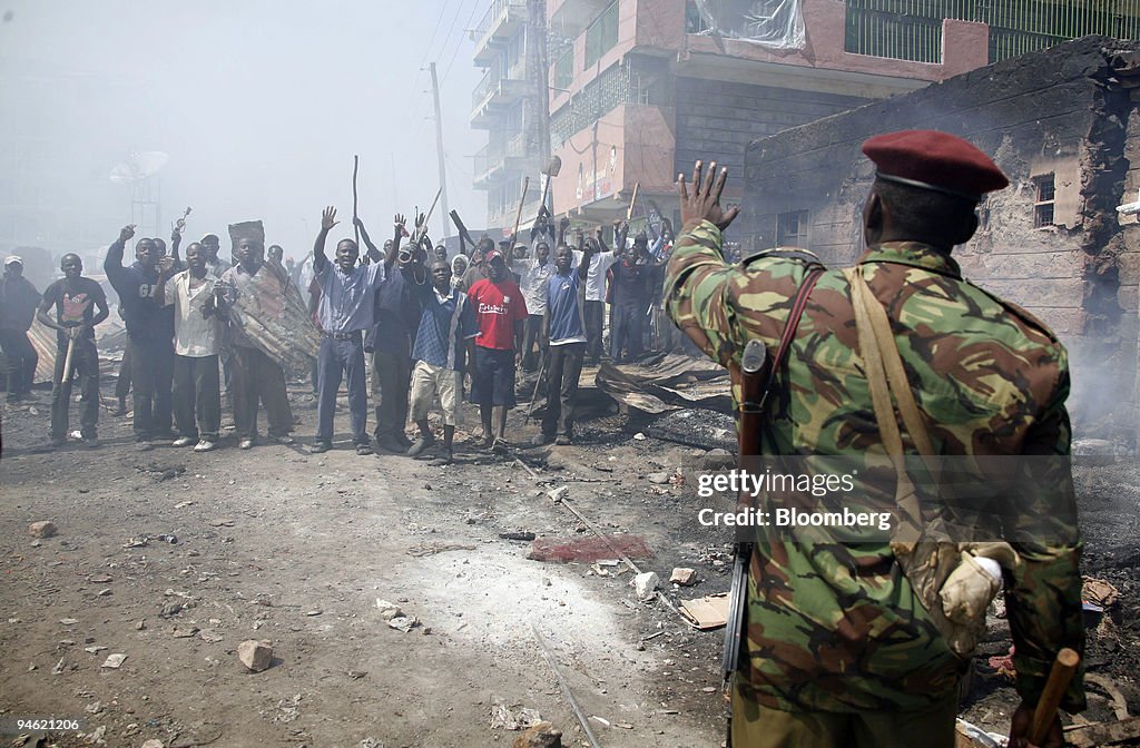 A member of the Kenyan army gestures to supporters of Raila