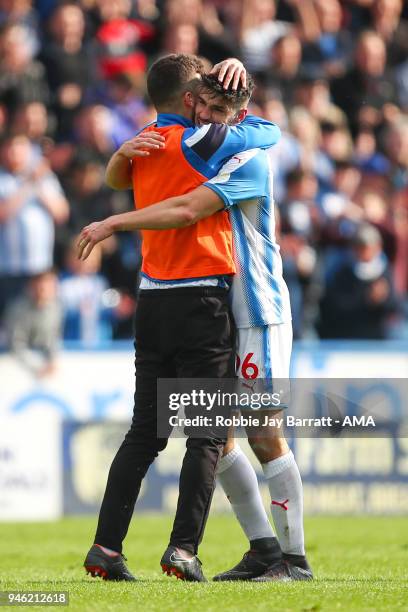 Tommy Smith of Huddersfield Town and Christopher Schindler of Huddersfield Town celebrate at full time during the Premier League match between...