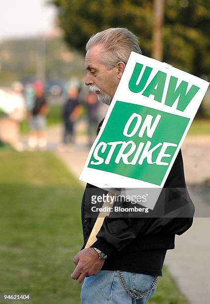 Dan Cronk, a 34-year employee of the General Motors Powertrain Tonawanda Engine Plant, holds a UAW on Strike sign outside the plant in Tonawanda, New...