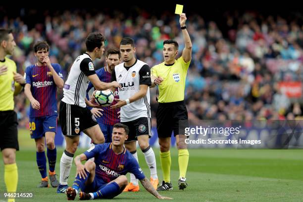 Gabriel Paulista of Valencia CF receives a yellow card from referee Carlos del Cerro during the La Liga Santander match between FC Barcelona v...