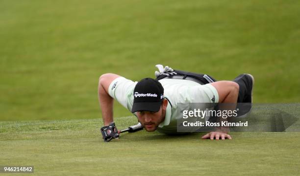 Bradley Neil of Scotland lines up his putt on the par four 16th hole during the third round of the Open de Espana at Centro Nacional de Golf on April...