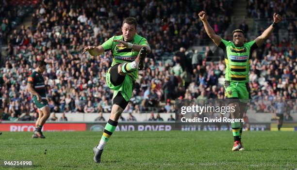 Stephen Myler of Northampton Saints clears the ball to touch to win the match as Luther Burrell celebrates during the Aviva Premiership match between...